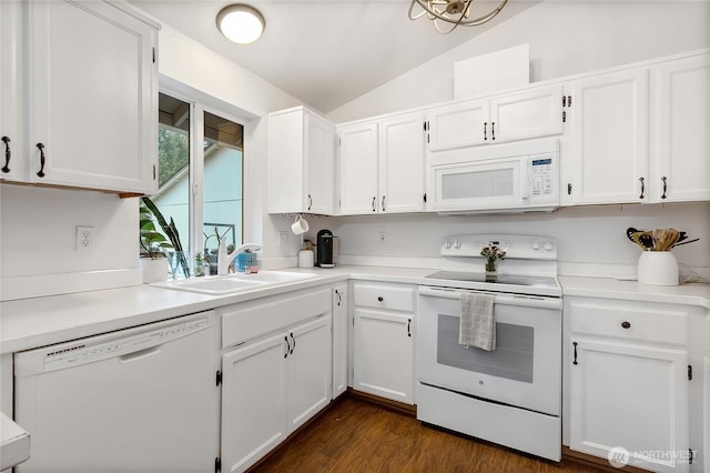 kitchen featuring white appliances, white cabinets, and a sink