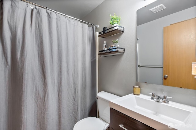 full bathroom featuring visible vents, vanity, and toilet