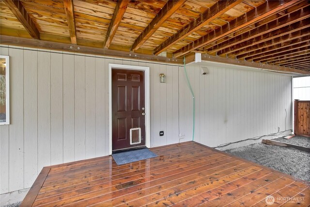 entrance to property featuring a wooden deck