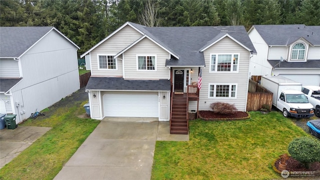 split foyer home with a garage, a shingled roof, fence, concrete driveway, and a front lawn