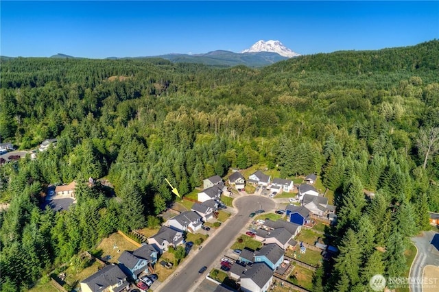 birds eye view of property with a forest view, a residential view, and a mountain view