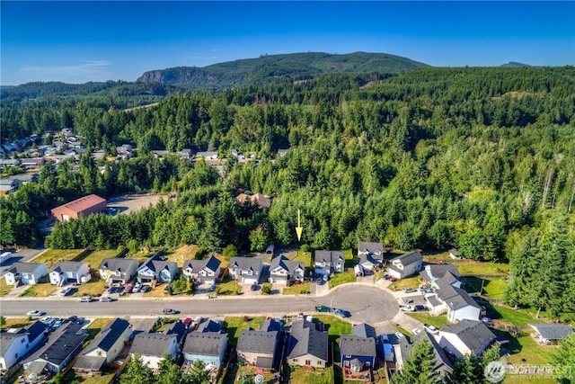 birds eye view of property with a forest view, a residential view, and a mountain view