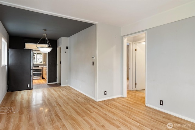 interior space featuring light wood finished floors and baseboards