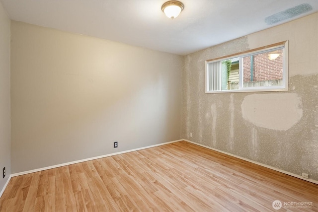 empty room featuring light wood-style flooring and baseboards