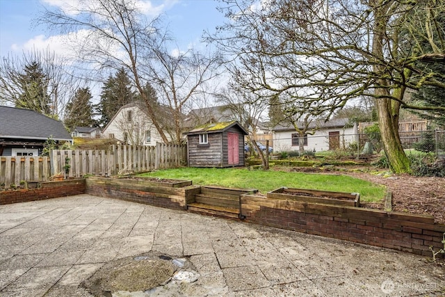 view of patio with a shed, a fenced backyard, and an outbuilding