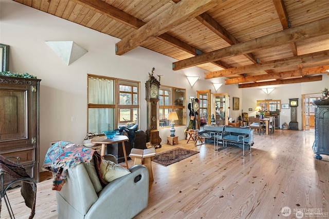 living area with wood ceiling, light wood-style flooring, and beam ceiling