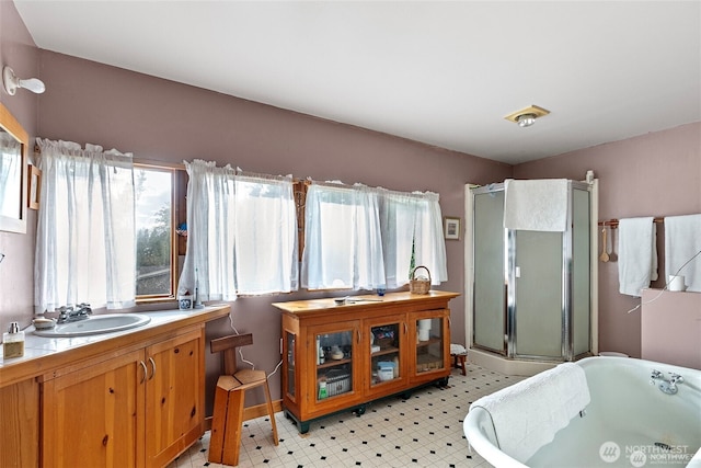 bathroom featuring a freestanding bath, a stall shower, vanity, and tile patterned floors