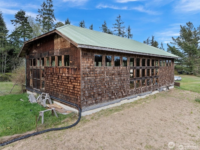 view of property exterior with metal roof