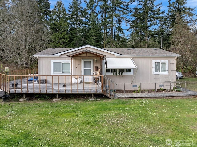 view of front of property featuring crawl space, a deck, and a front lawn