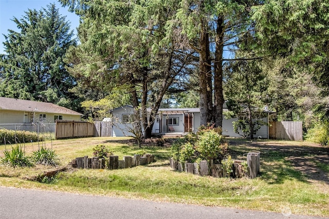 ranch-style home with fence