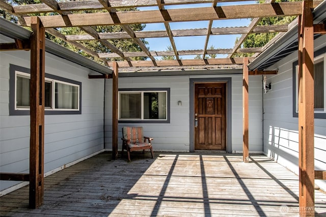 exterior space featuring metal roof, a deck, and a pergola