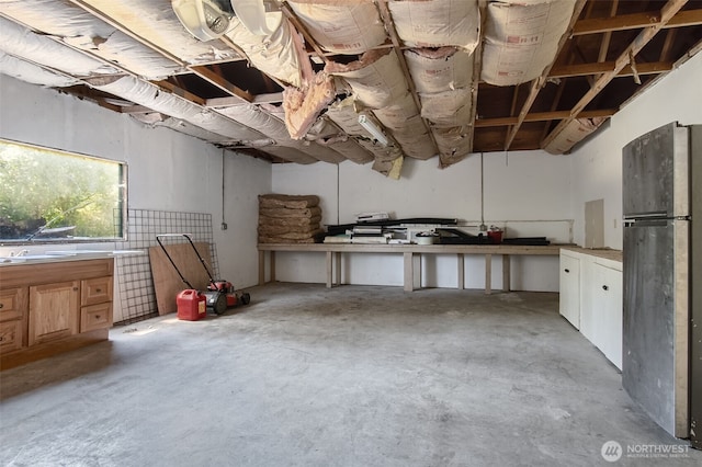 basement featuring freestanding refrigerator