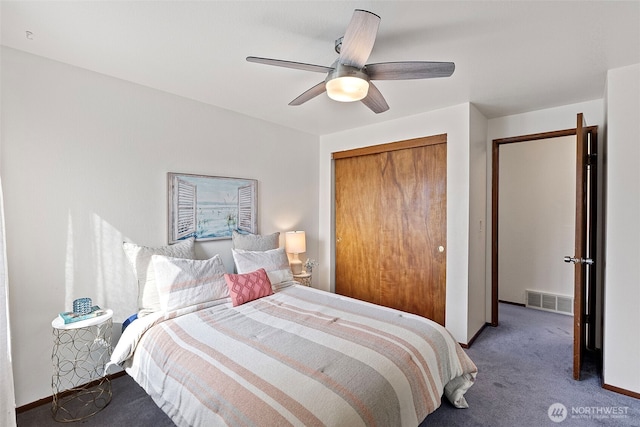 bedroom with visible vents, ceiling fan, baseboards, light carpet, and a closet