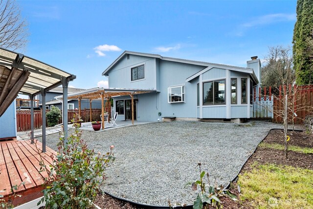 back of property with a patio, a fenced backyard, a chimney, and a pergola