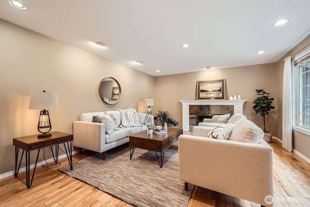 living room with light wood-style floors and recessed lighting