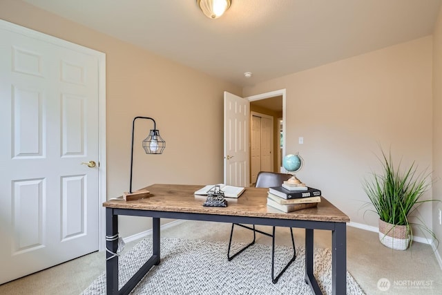 carpeted office featuring baseboards