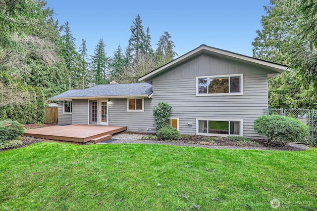 back of house featuring fence, a deck, a lawn, and french doors