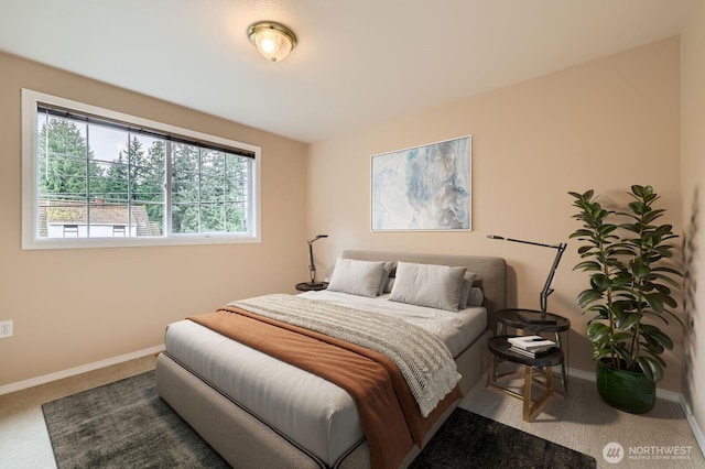 bedroom with carpet floors and baseboards