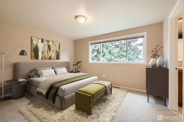 bedroom with carpet floors and baseboards