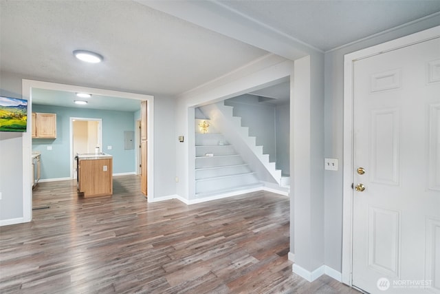 interior space featuring stairway, baseboards, and wood finished floors