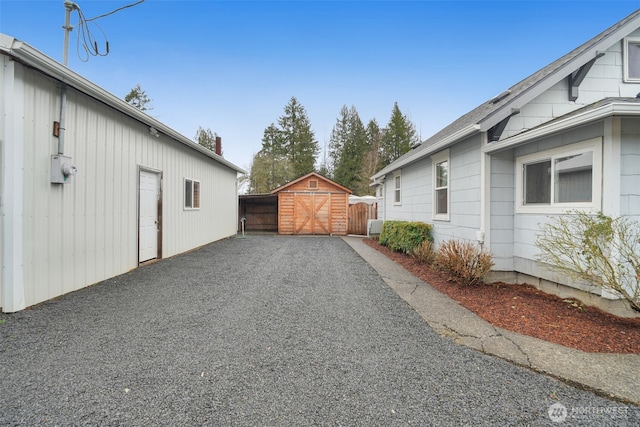 view of property exterior featuring an outbuilding and fence