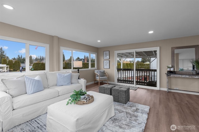 living room with recessed lighting, baseboards, and wood finished floors