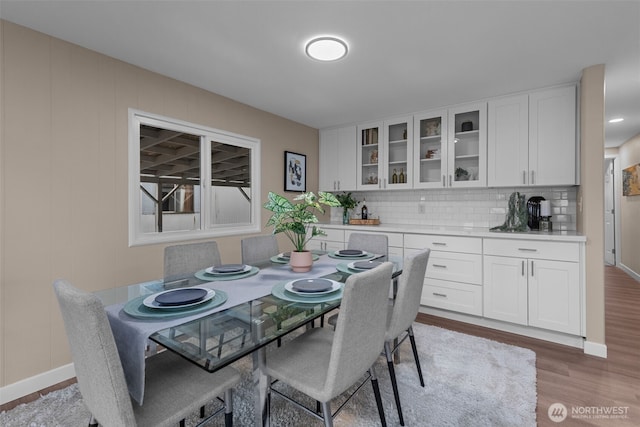 dining room with wood finished floors and baseboards