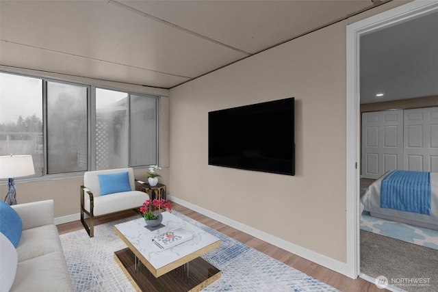 living area with wood finished floors and baseboards