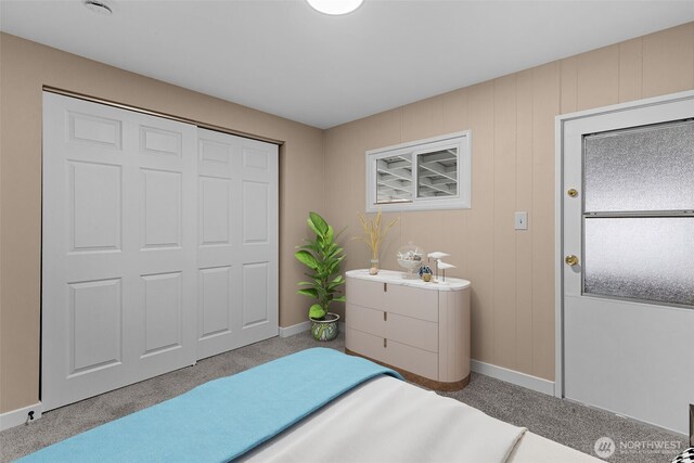 bedroom with light carpet, multiple windows, and baseboards