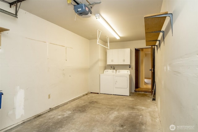 garage with a garage door opener and washer and dryer