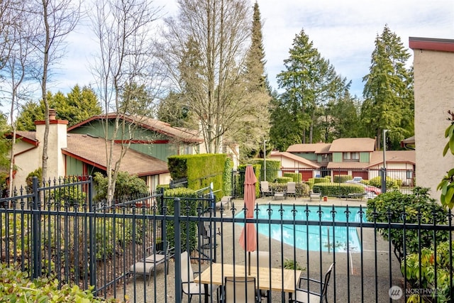 pool featuring a patio area and fence