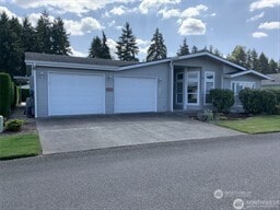 view of front of property featuring an attached garage and aphalt driveway