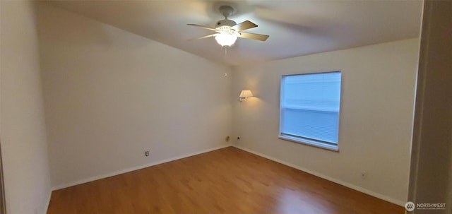 unfurnished room featuring ceiling fan, baseboards, and wood finished floors