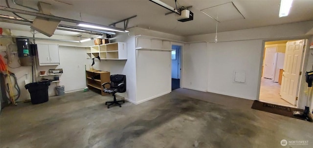 garage with freestanding refrigerator and a garage door opener