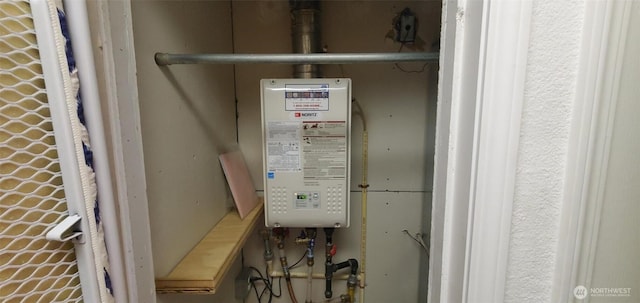 utility room featuring water heater