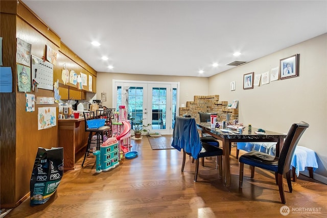 dining area with french doors, recessed lighting, visible vents, wood finished floors, and baseboards