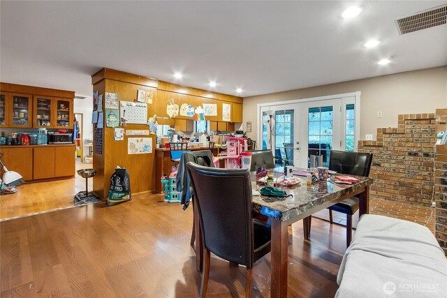 dining area featuring light wood-style floors, recessed lighting, french doors, and visible vents