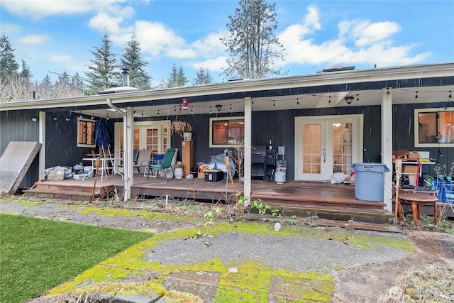 rear view of house with french doors and a wooden deck