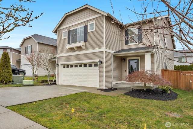 traditional-style home featuring a garage, concrete driveway, a front lawn, and fence