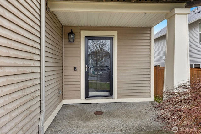 doorway to property with fence