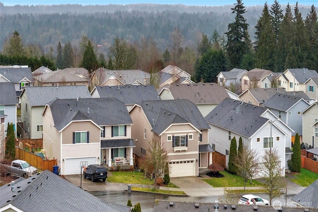 aerial view featuring a residential view and a forest view