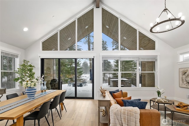 sunroom / solarium featuring lofted ceiling and a chandelier