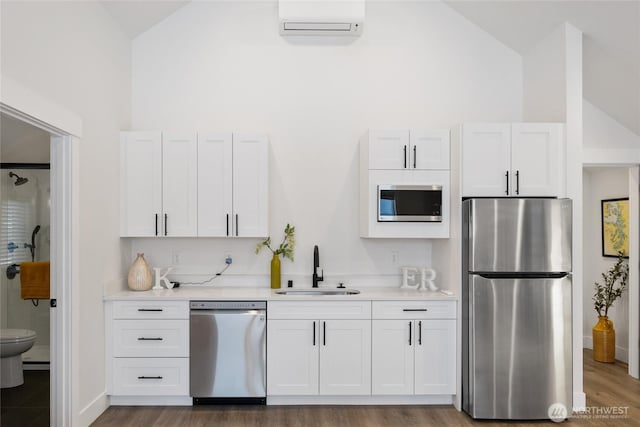 kitchen featuring light countertops, appliances with stainless steel finishes, a sink, and white cabinets