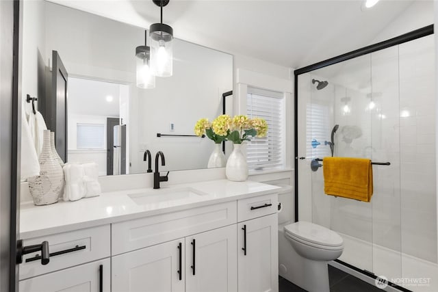 bathroom with vanity, a shower stall, toilet, and tile patterned floors