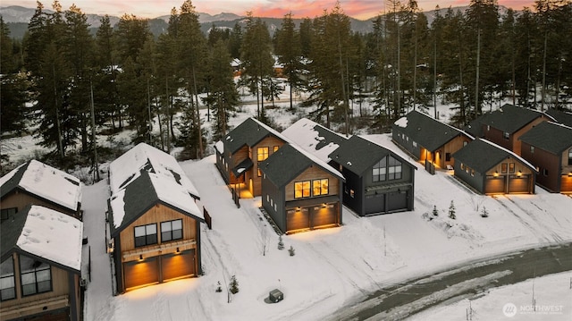 snowy aerial view featuring a residential view