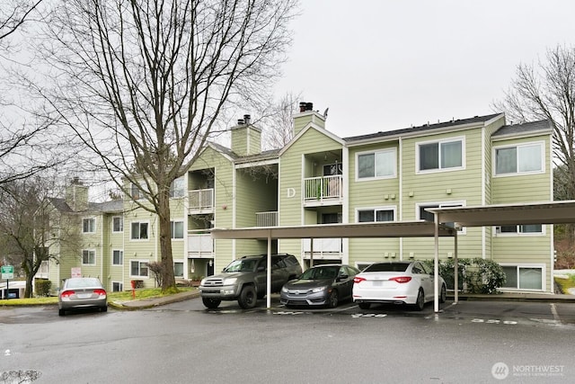 view of building exterior featuring covered parking