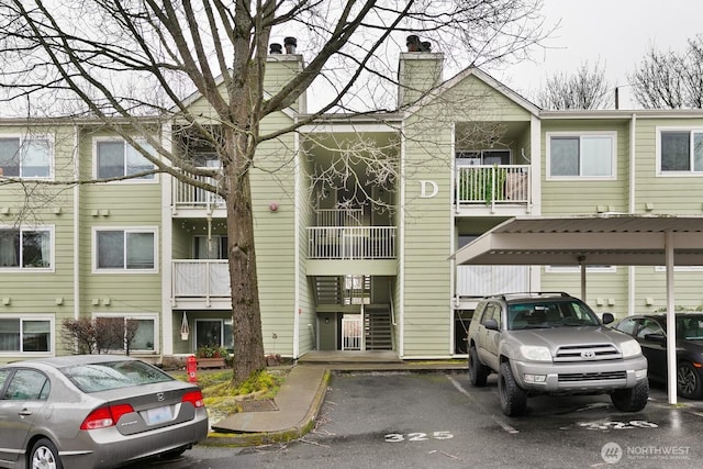 view of property with covered and uncovered parking