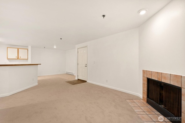 unfurnished living room featuring a tile fireplace, recessed lighting, a baseboard heating unit, light carpet, and baseboards