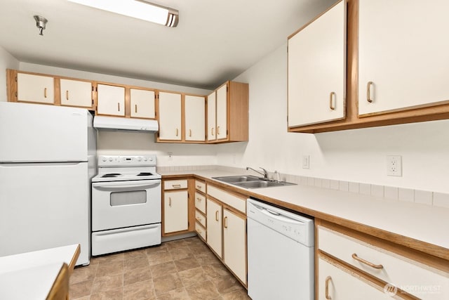 kitchen featuring white appliances, under cabinet range hood, light countertops, and a sink