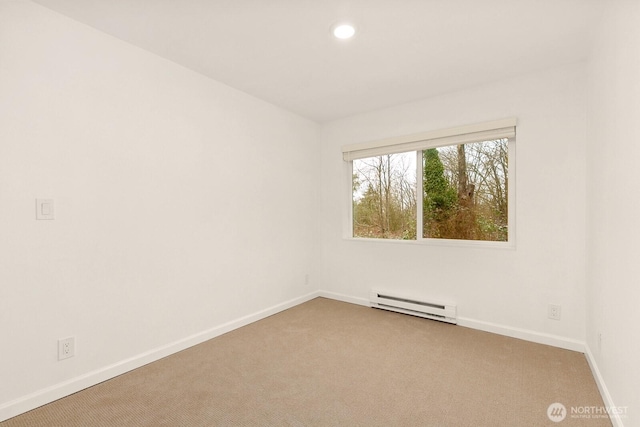 spare room featuring light carpet, a baseboard radiator, baseboards, and recessed lighting